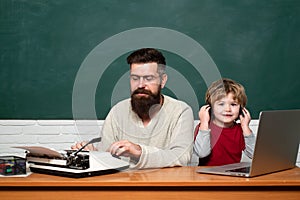 Daddy and his little son. Child learning. Teacher and kid. Happy family - daddy and son together. Daddy play with