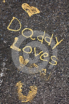 Daddy loves you statement written on concrete