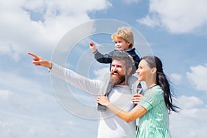 Daddy, mommy and child son. Happy family - child son playing with paper airplane. Portrait of happy father giving son