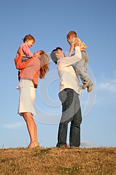 Daddy and mommy hold children photo