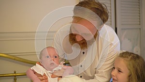 Daddy Playing With Newborn Baby and Bigger Sister