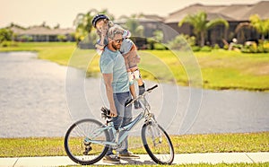 daddy and son spend time together. Strong family bonds. happy son and daddy cycling on bicycle. daddy teaching his son