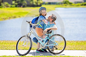 daddy teaching his son child to ride a bicycle. Embracing family unity. daddy and son kid outdoor. daddy and son spend