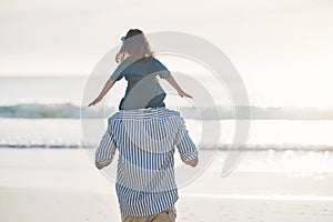 Daddys little girl. Rearview shot of an unrecognizable father carrying his young daughter on his shoulders during an