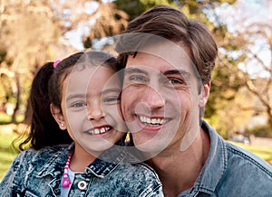 Daddys little golden girl. an adorable little girl spending quality time with her father at the park.