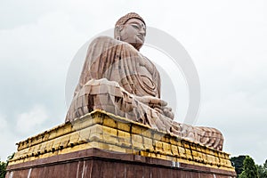 Daibutsu, The Great Buddha Statue in meditation pose or Dhyana Mudra seated on a lotus in open air near Mahabodhi Temple.