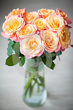 Dainty yellow-pink roses in a vase