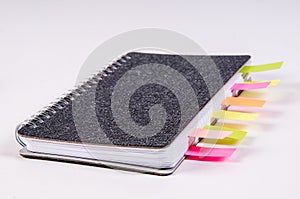 Dairies notepad with stickers and soft-tip pens on wooden background