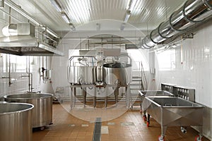 Dairy cheese factory interior with industrial appliances. Milk pasteurization, tank, bath and pipes