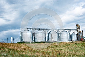 Dairy factory. Large cisterns of metallic color outdoors.