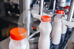 Dairy production, bottle of yoghurt on automated conveyor line, process of milk filling and packaging