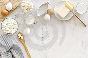 Dairy products from farm with milk, eggs, cottage, butter, yougurt on white marble background top view mockup