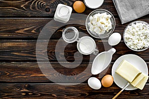 Dairy products from farm with milk, eggs, cottage, butter, yougurt on wooden background top view mockup