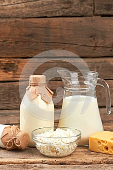 Dairy products on vintage wooden background.