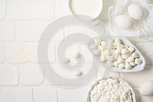 Dairy products on white background. Mozzarella, milk, eggs and cottage cheese. Top view from above