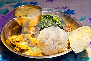 Dal Bhat, traditional Nepali meal platter with rice, lentils soup, vegetables, papadum and spices photo