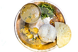 Dal Bhat, traditional Nepali meal platter with rice, lentils soup, vegetables, papadum and spices