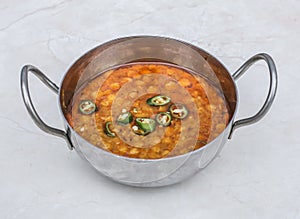 Dal chana fry served in karahi isolated on grey background side view of pakistani and indian spices food