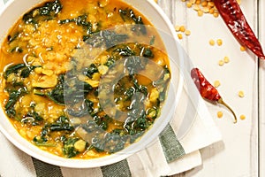 Dal Indian lentil curry soup with spinach photo