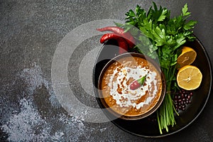 Dal Makhani at dark background. Dal Makhani - traditional indian cuisine puree dish with urad beans, red beans, butter, spices and