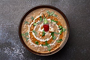 Dal Makhani at dark background. Dal Makhani - traditional indian cuisine puree dish with urad beans, red beans, butter, spices and