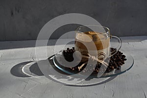 Dalgon coffee on a plate with coffee beans. It`s a hard light. Horizontal image