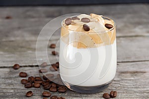 Dalgona coffee on rustic wooden background.