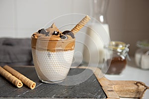 Dalgona coffee In a transparent glass. A trendy fluffy creamy whipped coffee