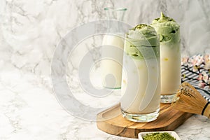 Dalgona Matcha Latte, a creamy whipped matcha, on light background. Matcha green tea.whipped grean tea with milk photo