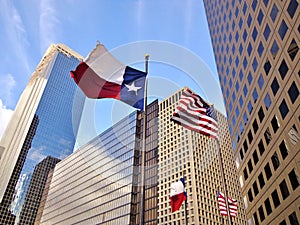 Dallas Flag and United States Flag Waving in the Wind - Downtown Houston, Texas