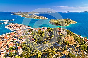 Dalmatian town of Tribunj church on hill and amazing turquoise archipelago aerial view