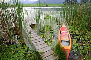 Dam with jetty and canoe in the Garden Route, South Africa
