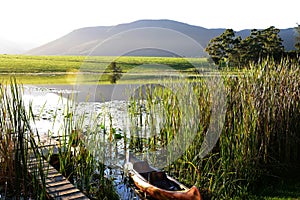 Dam with jetty and canoe in the Garden Route, South Africa