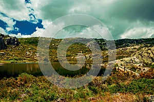 Dam lake among rocks and bushes on highlands