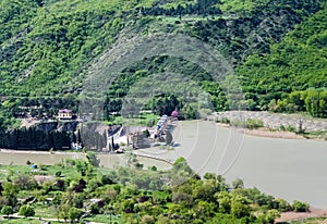 Dam of the old hydroelectric power plant on the river Kura downstream from Mtskheta in Georgia