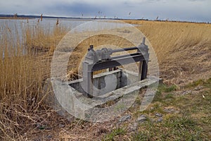 dam-old water damper used to accumulate and stop water flowing from fields and meadows. melioration device photo
