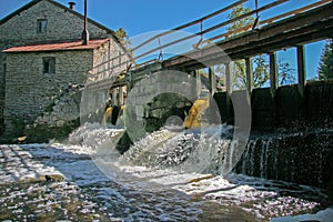 Dam at the old water mill made of stones.
