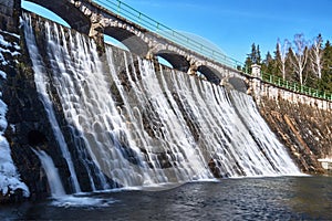 The dam and waterfall on the river Lomnic