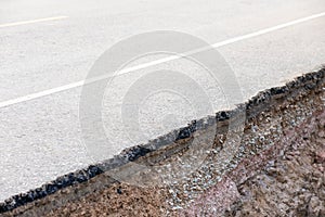 Damage of asphalt road at countryside cause of heavy rain and sliding earth