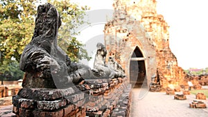 Damage Buddha statue, have blur on old wall brick gate arch back