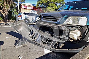 Damage car crushing against road side guard gutter in early morning at Sydney suburb