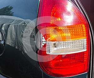 Damage to the taillight of the car, accident. Car insurance, background, close-up
