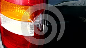 Damage to the taillight of the car, accident. Car insurance, background, close-up, deformation