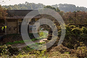 Damaged 1970s` dwelling building of former 630 factory in sunny winter afternoon