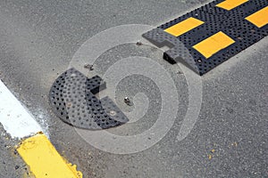 Damaged artificial road unevenness. Sleeping policeman.