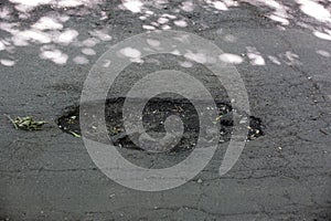 Damaged asphalt pavement road with pothole