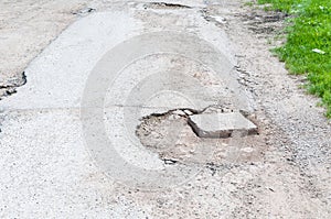 Damaged asphalt road with deep holes