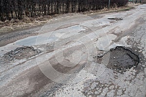 Damaged asphalt road after winter.