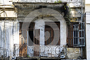 Damaged balcony and wooden shutters in an abandoned building in Achrafieh, architecture of old heritage buildings in Beirut, Leban
