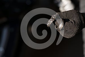 Damaged bearing in the hand of a mechanic